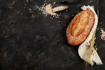 Bread assortment on dark background. - obrazy, fototapety, plakaty