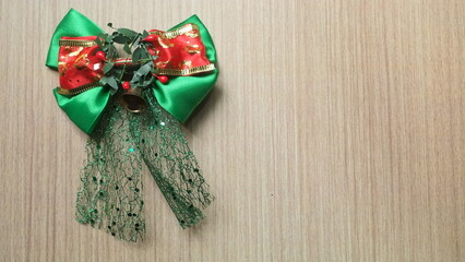 beautiful green christmas decoration with ribbon on wooden board
