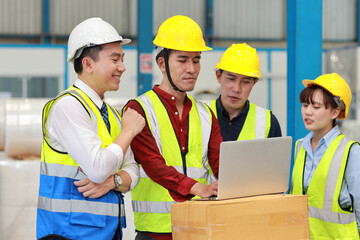 Group of technician engineer and businessman in protective uniform standing and discussing, researching, brainstorming and planning work with computer together at industry manufacturing factory