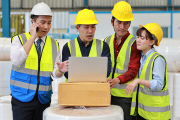 Group of technician engineer and businessman in protective uniform standing and discussing, researching, brainstorming and planning work with computer together at industry manufacturing factory