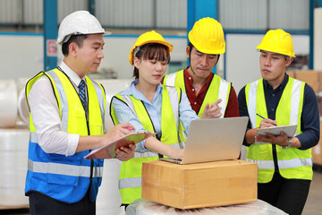 Group of technician engineer and businessman in protective uniform standing and discussing, researching, brainstorming and planning work with computer together at industry manufacturing factory