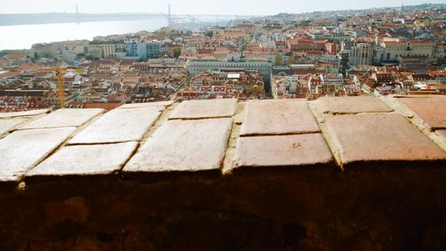 Cinematic shot of Lisbon, Portugal, overseeing the entire downtown, the Tagus river and the Ponte 25 de Abril bridge in Lisbon, Portugal