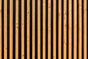 Texture, background, close-up of wooden slats.Vertical wooden boards on the wall