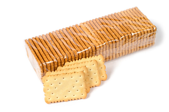 Packing cookies on a white background. Biscuits in plastic packaging. In the foreground are cookies without packaging.