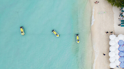 Natural Beach concept summer vacation. Nature of tropical summer beach. Umbrella board a boat and boat on the Sand Beach and Tourism Happy for playing on sand.