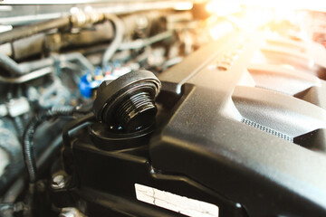 Motor oil cap of the automotive engine on plastic cover in the engine compartment , auto maintenance service concept