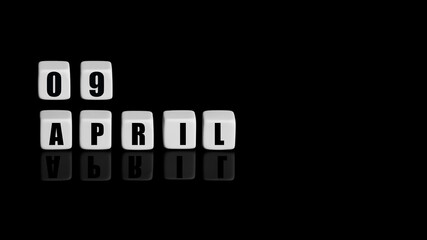 April 9th. Day 9 of month, Calendar date. White cubes with text on black background with...