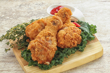 Fried chicken drumsticks with tomato sauce