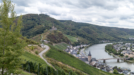 Landscape photo Vineyards with castle in Bernkastel on the Moselle in Rhineland-Palatinate, Germany. cloudy sky