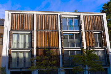 Close-up of facade of modern apartment a City of Basel with wooden shutters o a sunny summer morning. Photo taken August 24th, 2022, Basel, Switzerland.