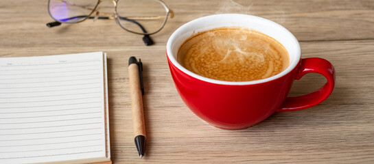 blank notebook and coffee cup on wood table. Motivation, Resolution, To do list, Strategy and Plan concept