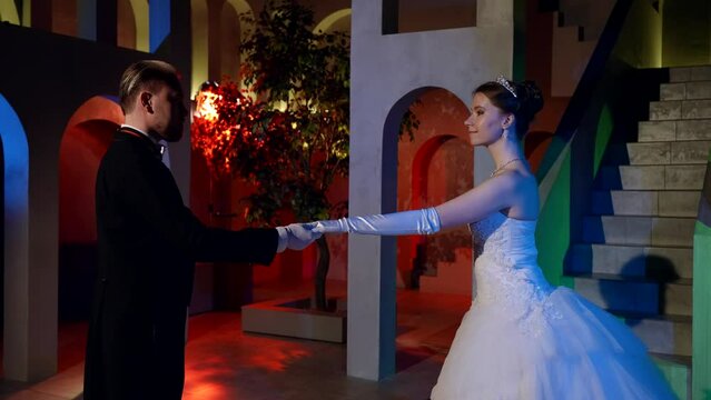 beautiful young princess and elegant prince are starting to dance in ballroom, fabulous royal ball