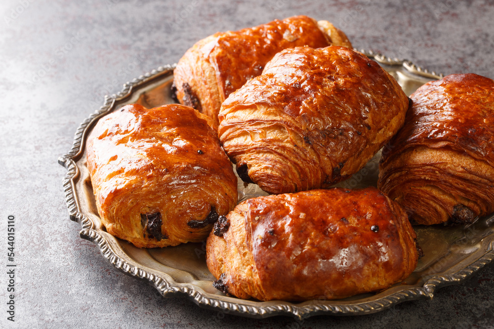 Wall mural freshly backed french traditional croissants chocolate petit pain au chocolat closeup in the plate o