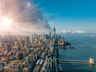 Aerial view of New York Lower Manhattan buildings and pier on Hudson River. Light effect applied