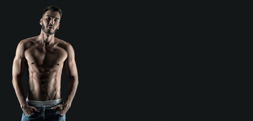 Fototapeta na wymiar young man with muscular torso and abs isolated on black background. studio shot of muscular man.