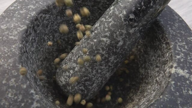 Green pepper poured into a mortar