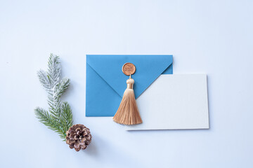 Turquoise envelope with a white sheet of paper and New Year's attributes