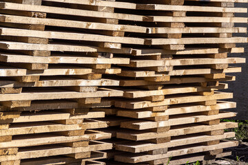 Wooden industrial coasters stacked for storage in anticipation of use, selective focus