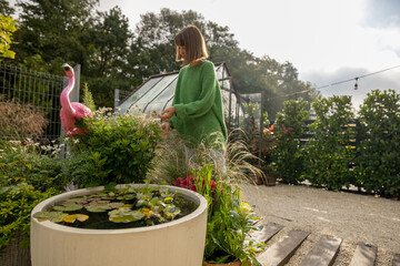 Beautiful green yard with a woman gardening