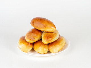 Pies on a white plate on a white background.