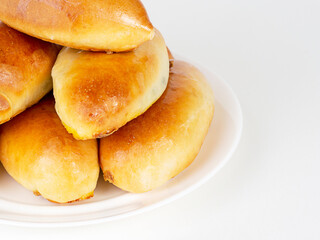 Pies on a white plate on a white background.