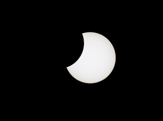 Partial solar eclipse against black sky