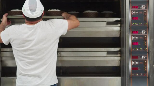 chef cooking italian christmas sweet bread panettone baking on industrial oven in bakery