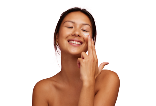 Happy young woman applying a moisturising face cream on a transparent background
