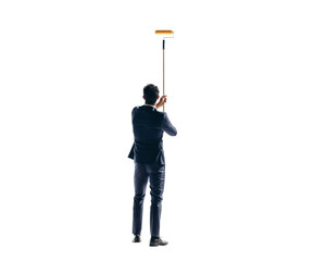 Rearview of a business man painting a wall with a roller on a transparent background