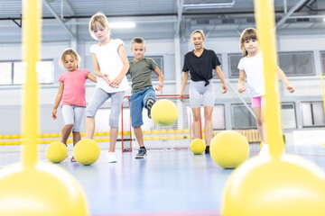 Students playing with ball at school sports court
