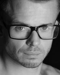 Young attractive guy. Black background.