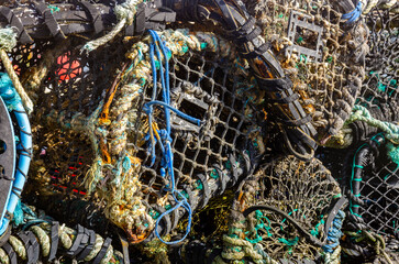 Lobster pots piled up on the quayside at Mudeford near Christchurch in Dorst, UK