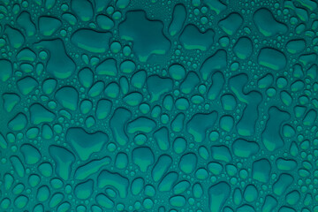Water drops on deep turquoise or green background as saturated stylish texture, pattern with...