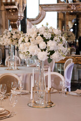 Tables setting at a luxury wedding. Table for guests. Dishes and drinks. Wedding table preparation.