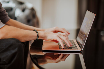 Teenage student typing on laptop and e-learning at home