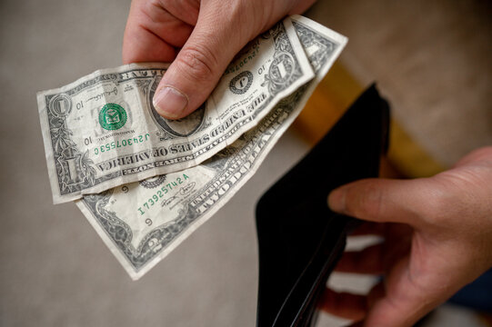 Hands of man removing money from wallet