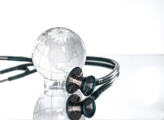 Studio shot of stethoscope pointed at glass globe