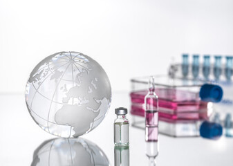Studio shot of glass globe and medical vials