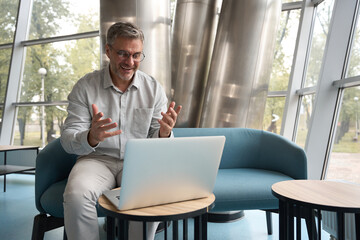 Middle-aged man in glasses communicates online with a subordinate