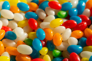 Heap of multi-colored glossy candies that look like wet sea pebbles