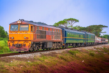 Passenger train by diesel locomotive on the railway.