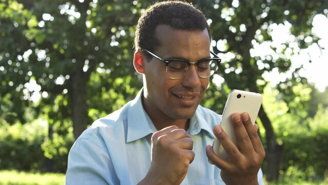 Nervous biracial man checking email, rejoicing receiving long-waited letter