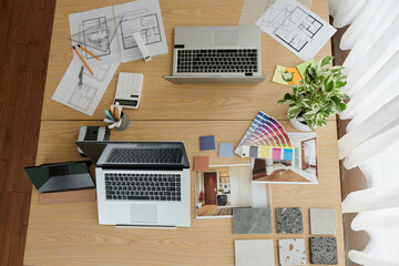 Documents with House Plan on Desk of Interior Designer