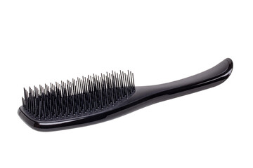 Closeup of a stylish new black hair brush isolated on white background. Concept of body and beauty care. Clipping path. Macro.