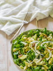 bowl of healthy salad presented on a table with a fork