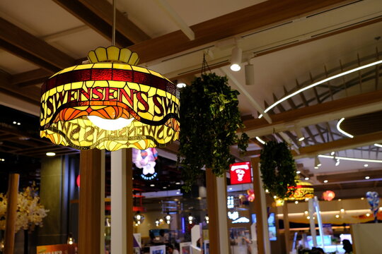 BANGKOK, THAILAND - OCTOBER 31, 2022: Vintage Stained Glass Ceiling Light with Swensens Name on the Lamp. Swensens was started in 1948 by Earle Swensen.
