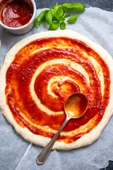Poster Cooking pizza, tomatoe sauce on raw dough. Homemade sourdoguh pizza dough, top view © Inga