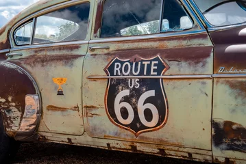 Poster Williams, USA. September 16, 2022. Route 66 on old rustic car at Grand canyon railway junction. Text and number on vintage vehicle at city of Williams during summer. © ingusk