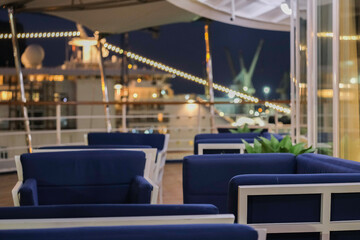 Champagne sparkling wine and cocktail longdrink on outdoor patio terrace deck of luxury cruiseship cruise ship liner yacht in port pre dinner drinks bar service