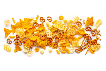 Salty snacks texture on a white background. Party food mix. Potato and tortilla chips, crackers and...